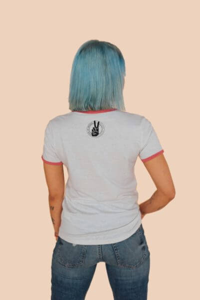 Model standing with her back to the the viewer showcasing the Eco-Ethical brand Viva La Vegan's white Animal Liberation Tshirt