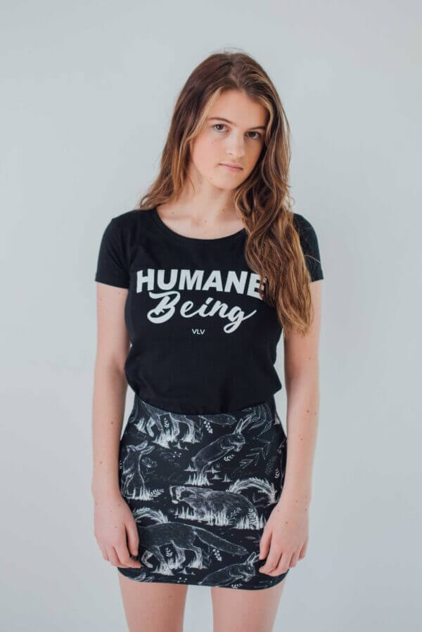 Female modelling the front of a black humane being vegan tshirt on a white background on behalf the Eco ethical vegan brand Viva La Vegan.