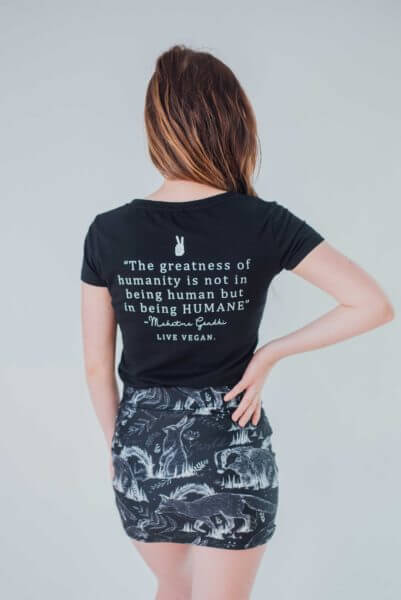 Female modelling the back of a black humane being vegan tshirt on a white background on behalf the Eco ethical vegan brand Viva La Vegan.