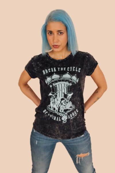 Woman modelling a pair of ripped jeans and acid black Break The Cycle organic cotton vegan tshirt. T-shirt created by award winning eco-ethical Viva La Vegan Clothing Brand.