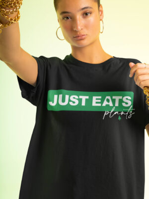 Short haired woman wearing an over sized Tshirt with the print Just Eats Plants