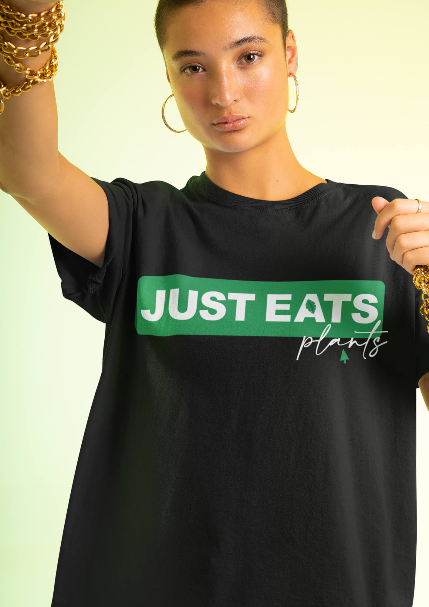 Short haired woman wearing an over sized Tshirt with the print Just Eats Plants