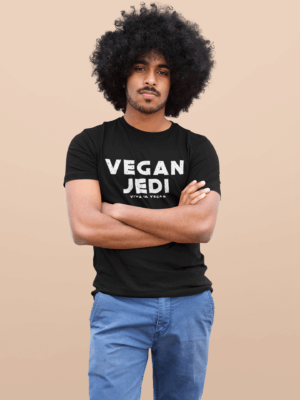 Unisex Vegan Jedi Tshirt in bMale Model with Afro-Hair wearing blue jeans and one of eco -ethical brand Viva La Vegans Vegan Jedi T-shirt in Black.