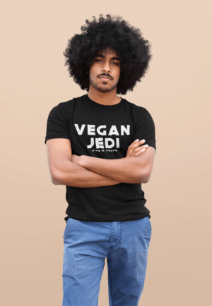 Unisex Vegan Jedi Tshirt in bMale Model with Afro-Hair wearing blue jeans and one of eco -ethical brand Viva La Vegans Vegan Jedi T-shirt in Black.