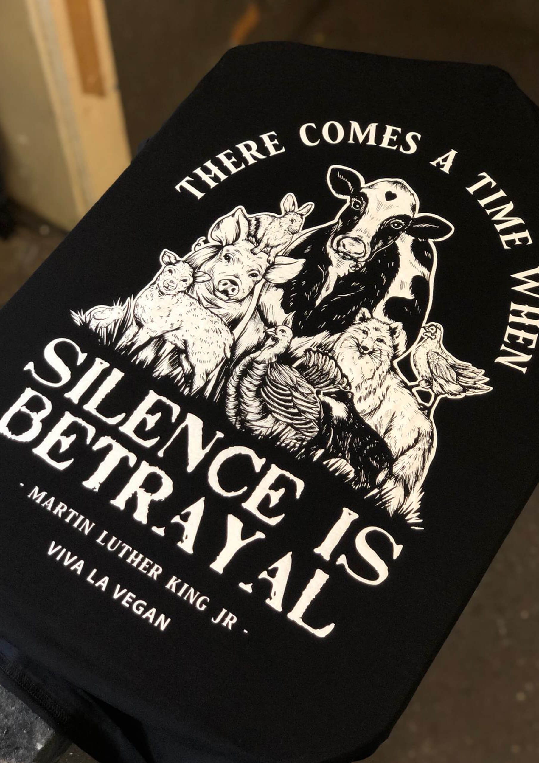 Detailed display of vegan Tshirt graphics. Silence equals violence print detail
