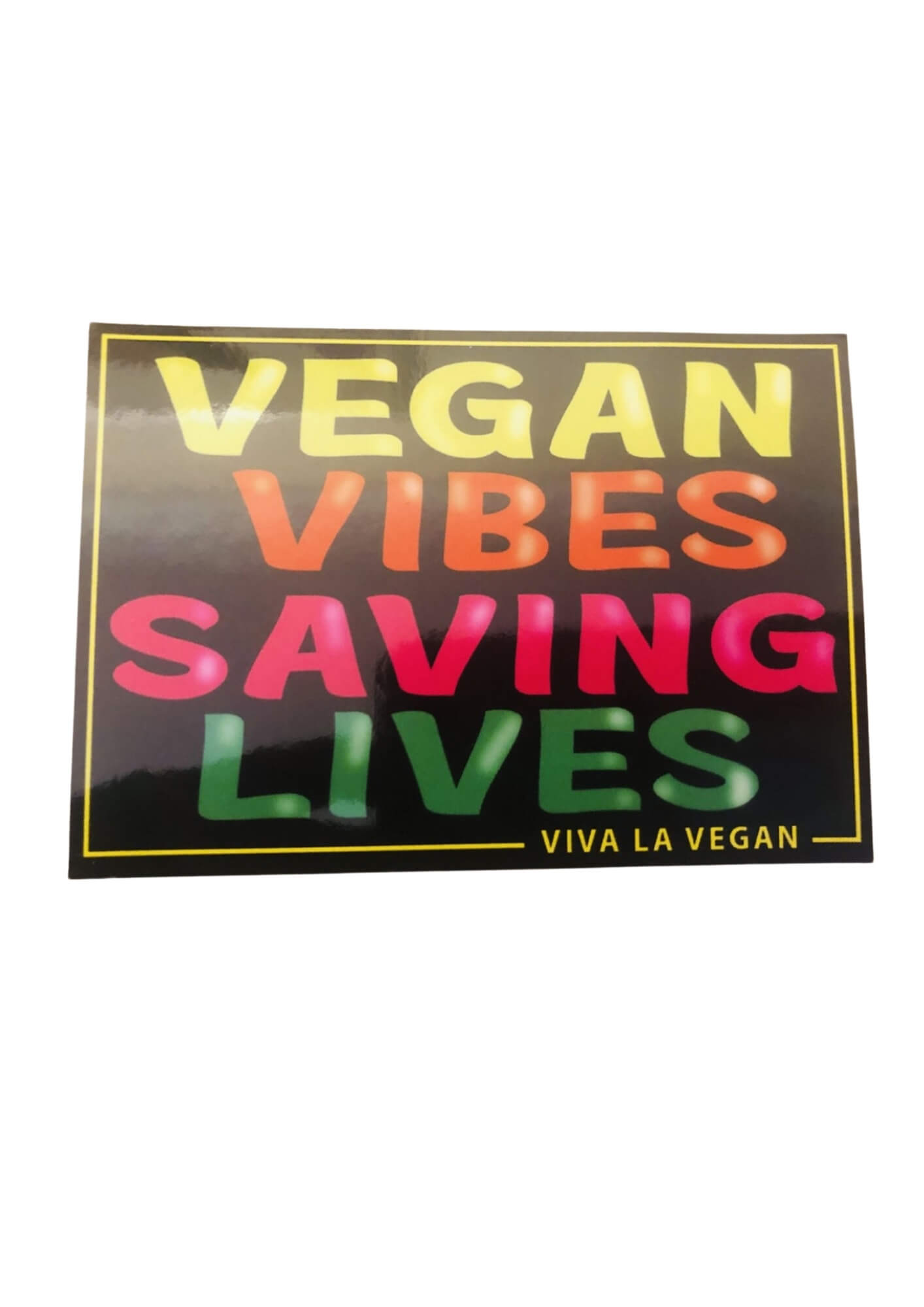 Photo of a vegan statement window cling that says "Vegan Vibes Saving Lives" as designed by Viva la Vegan