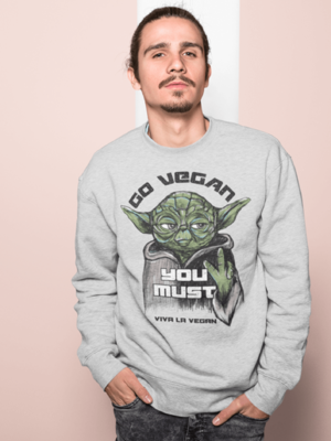 Young man wearing a Go Vegan you must grey marl sweatshirt by eco-ethical brand Viva La Vegan