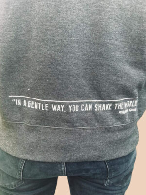 Human Kind sweatshirt back print detail with a quote ' in a gentle way you can shake the world'