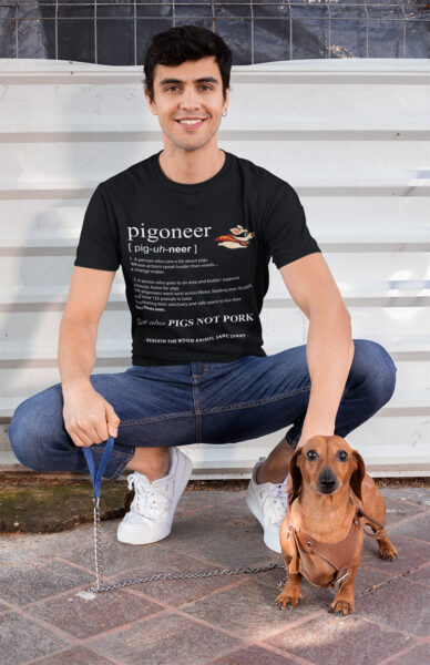 Man posing with his dog wearing a black pigoneer tshirt by Viva La Vegan